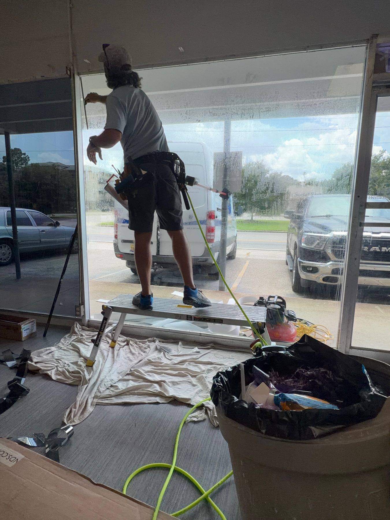 An eight-foot commercial pane being filmed from a work plank