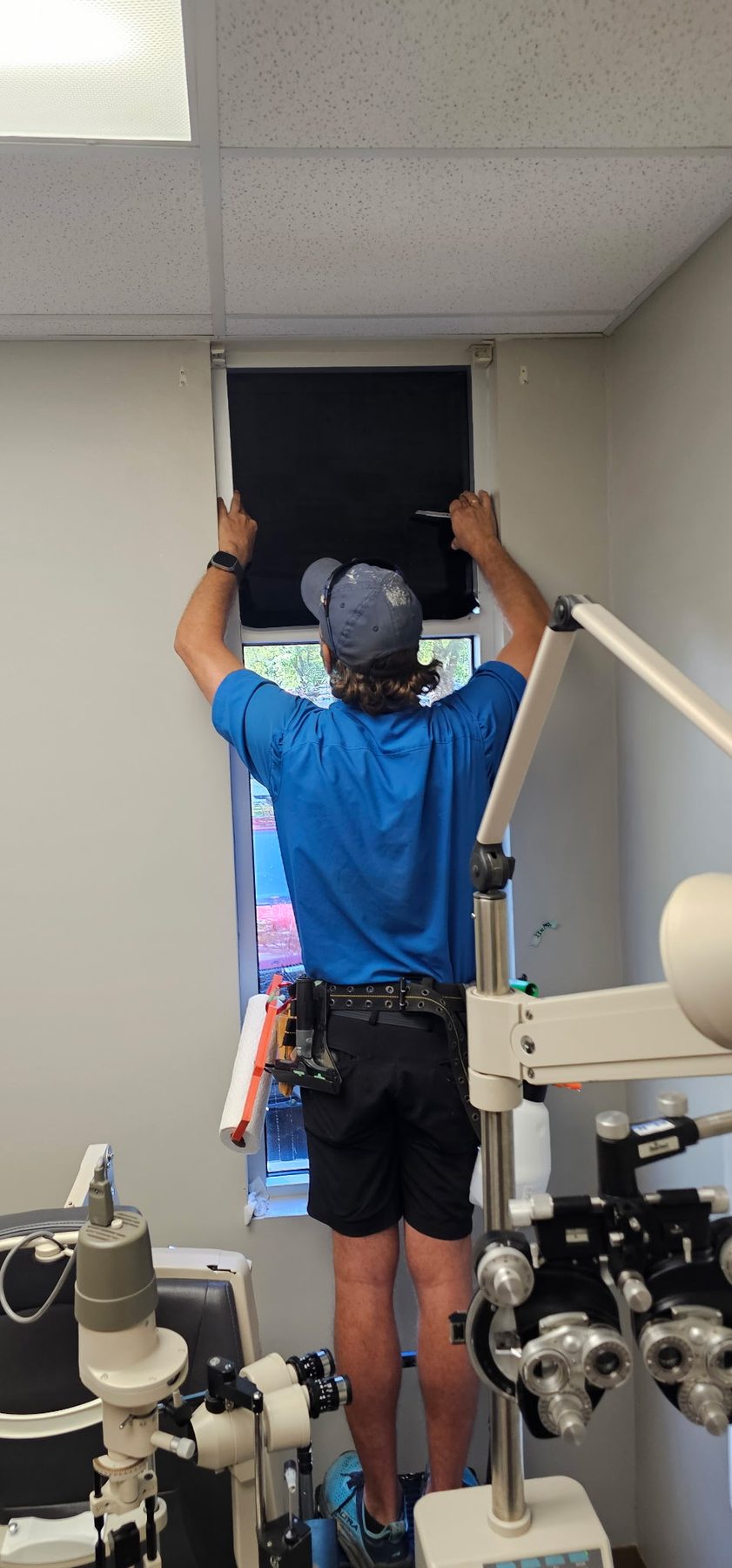 Blackout film going onto a window in an eye exam room