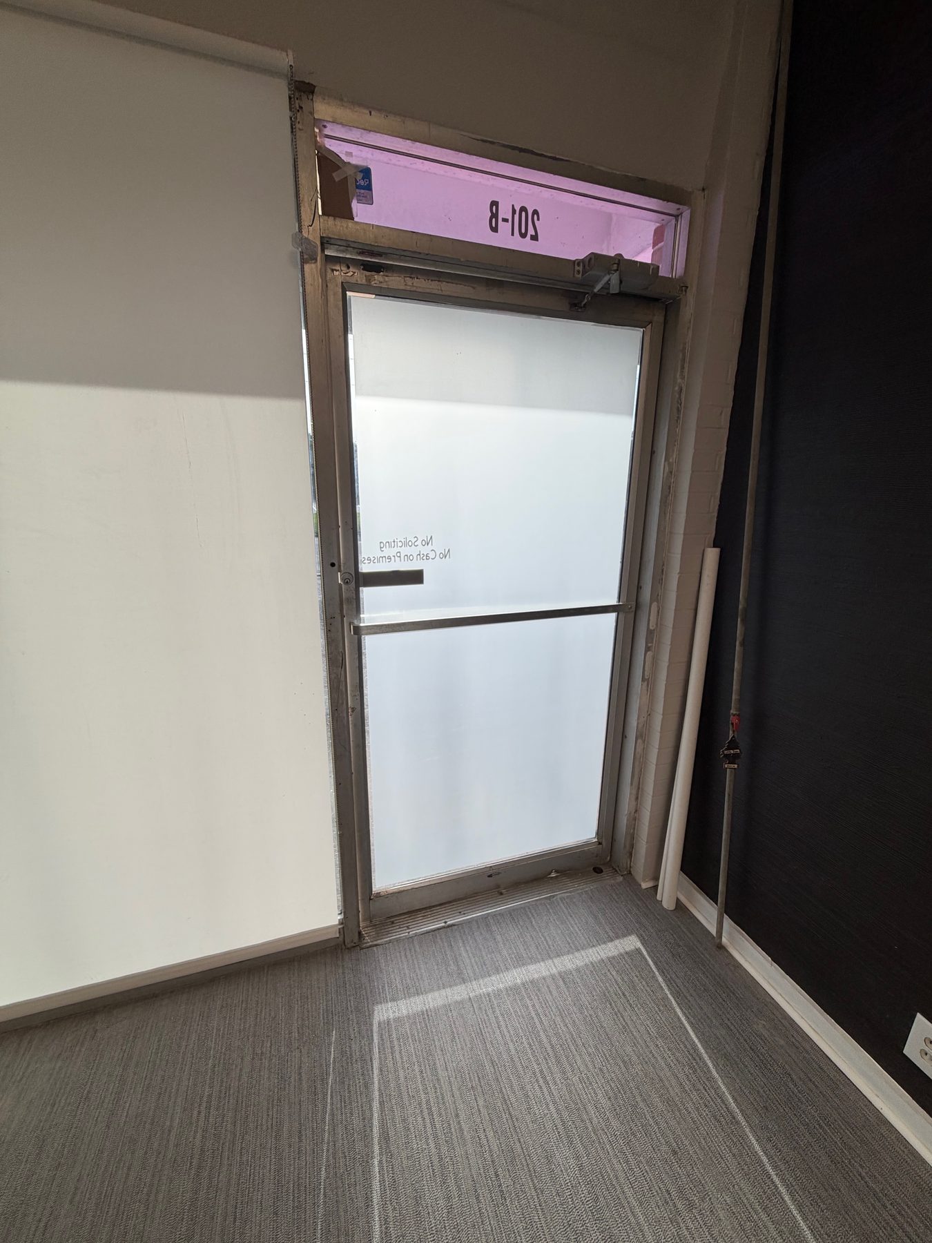 A commercial door with heat film and frost stacked for full privacy