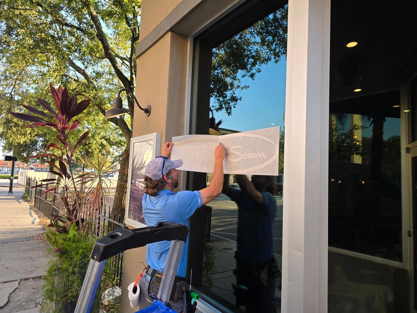 Storefront glass with applied lettering in Mobile